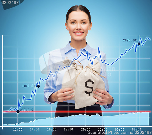 Image of businesswoman holding money bags with euro