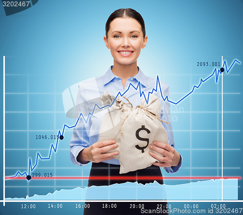 Image of businesswoman holding money bags with euro