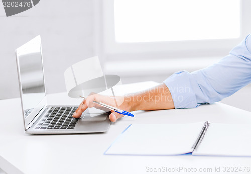 Image of smiling businessman working in office