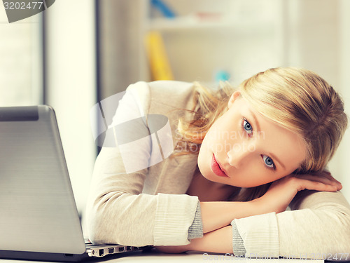 Image of tired woman with laptop computer