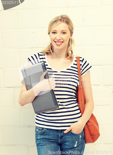 Image of happy and smiling teenage girl with laptop