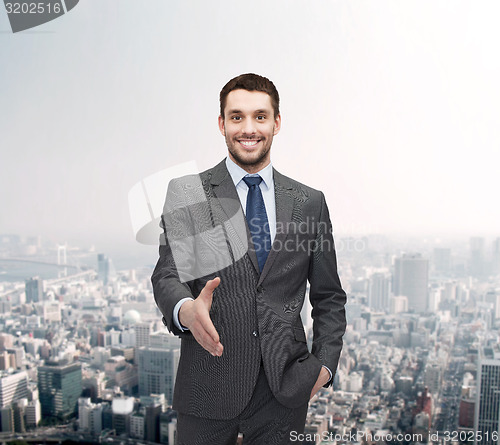 Image of businessman with open hand ready for handshake