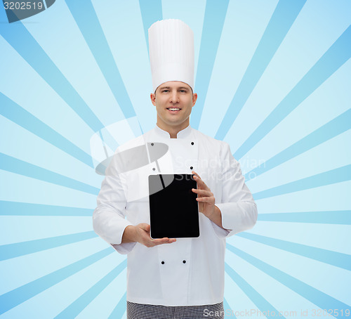 Image of happy male chef cook showing tablet pc