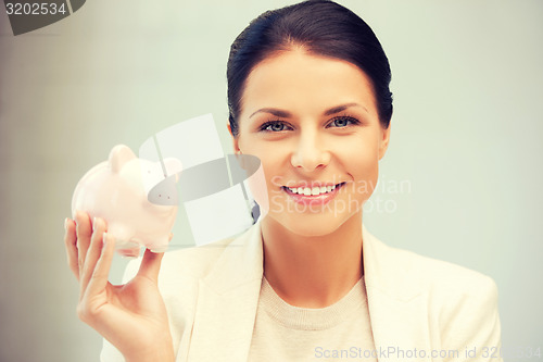 Image of lovely woman with piggy bank