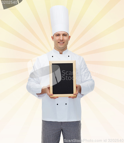 Image of happy male chef cook holding blank menu board