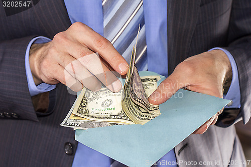 Image of Counting dollars bribe