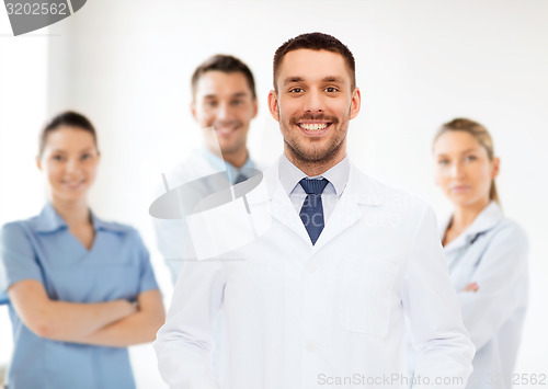 Image of smiling male doctor in white coat