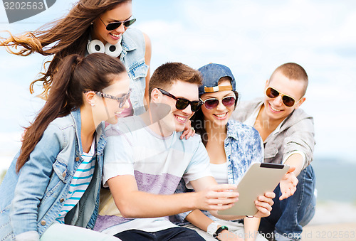 Image of group of teenagers looking at tablet pc