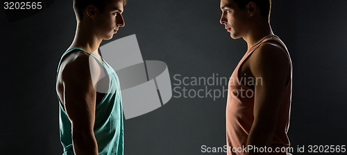 Image of young men looking to each other