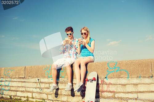 Image of smiling couple having fun outdoors