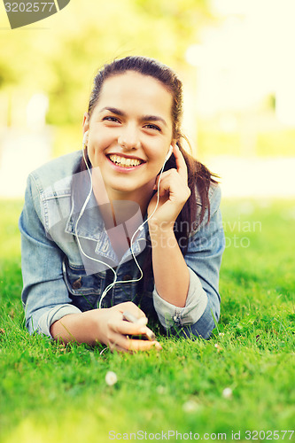Image of smiling young girl with smartphone and earphones