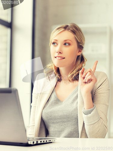 Image of woman with laptop and finger up