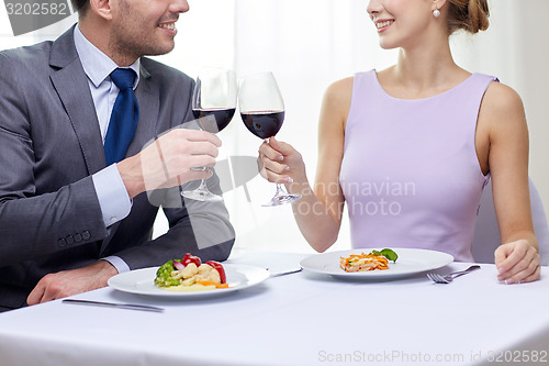 Image of happy couple with glasses of wine at restaurant
