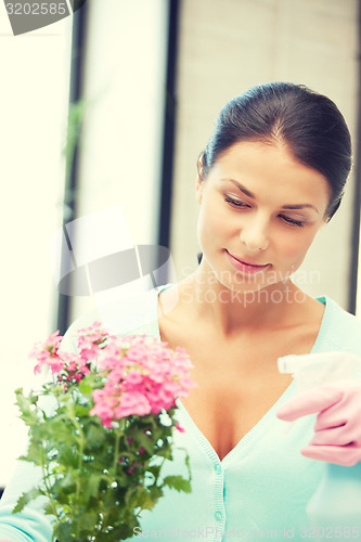 Image of lovely housewife with flower