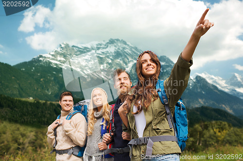 Image of group of smiling friends with backpacks hiking