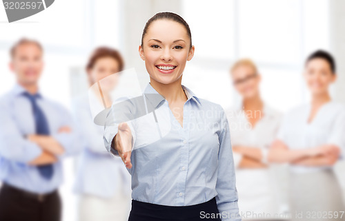 Image of businesswoman with opened hand ready for handshake