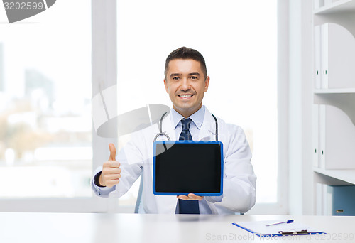 Image of smiling doctor showing tablet pc and thumbs up