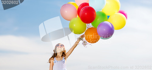 Image of happy girl with colorful balloons