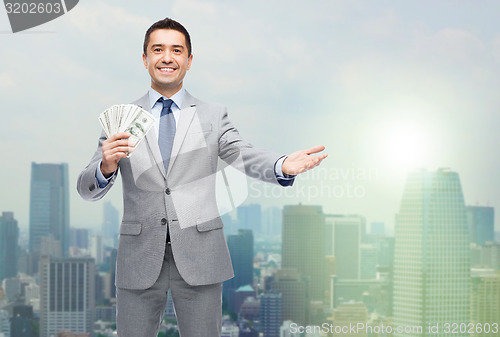 Image of smiling businessman with american dollar money