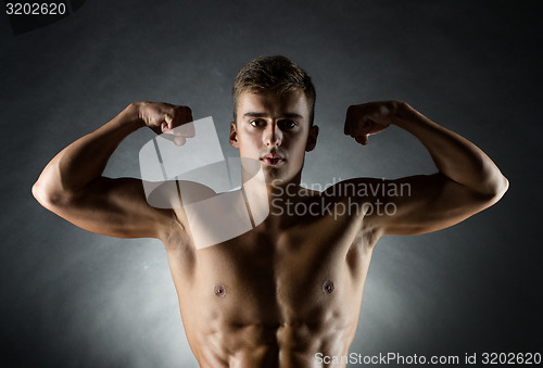 Image of young man showing biceps