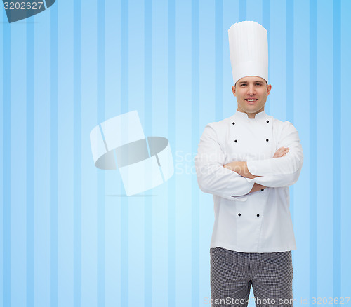 Image of happy male chef cook with crossed hands