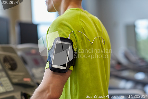 Image of close up of man exercising on treadmill in gym
