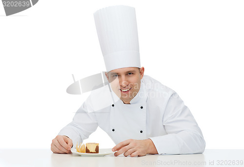 Image of happy male chef cook with dessert
