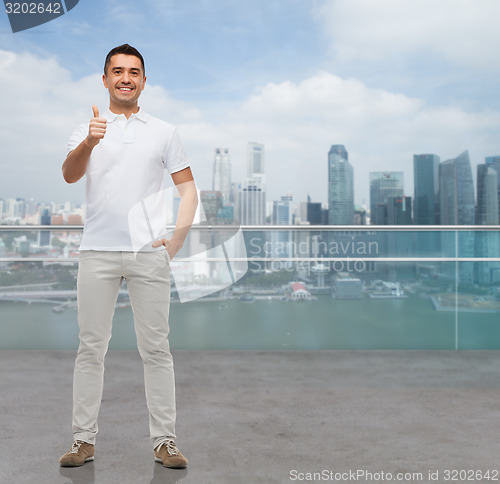 Image of smiling man showing thumbs up