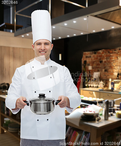 Image of happy male chef cook holding pot