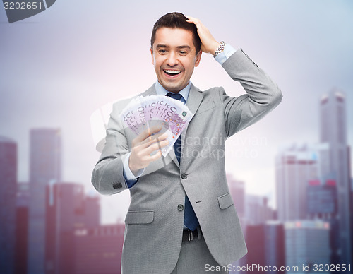 Image of happy laughing businessman with euro money