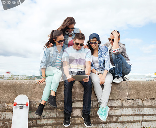 Image of group of teenagers looking at tablet pc