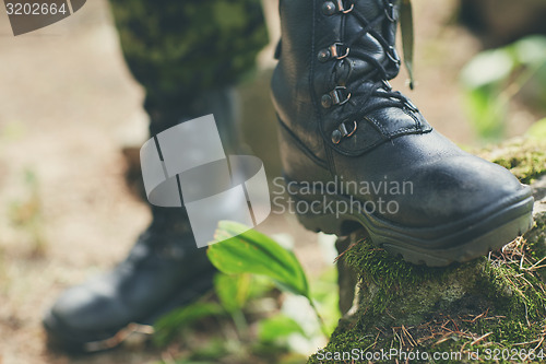 Image of close up of soldier feet with army boots in forest