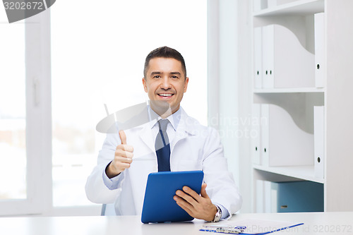 Image of smiling doctor with tablet pc showing thumbs up