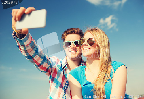 Image of smiling couple having fun outdoors