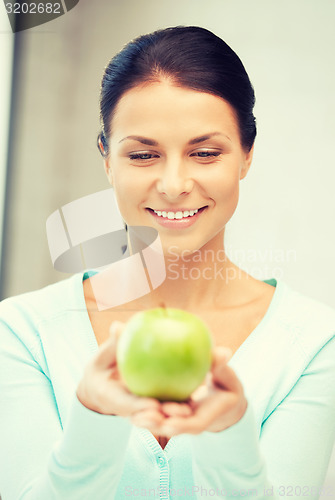 Image of lovely housewife with green apple