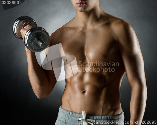 Image of young man with dumbbell