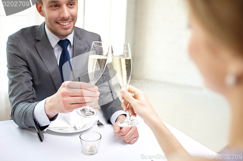 Image of couple with glasses of champagne at restaurant