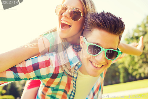 Image of smiling couple having fun in park