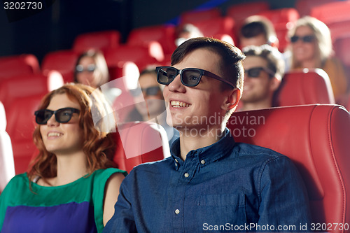 Image of happy friends watching movie in 3d theater