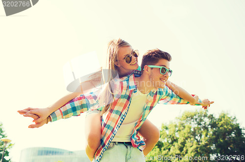 Image of smiling couple having fun in park