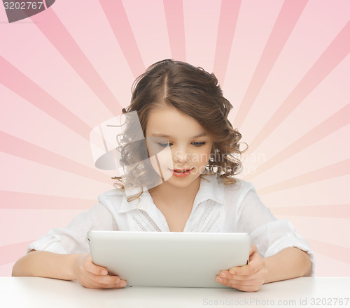 Image of girl holding and looking to tablet pc computer