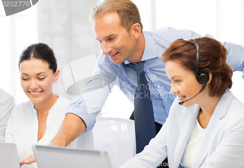 Image of group of people working in call center