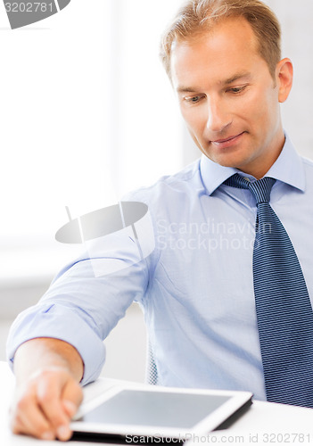 Image of businessman with tablet pc and coffee in office