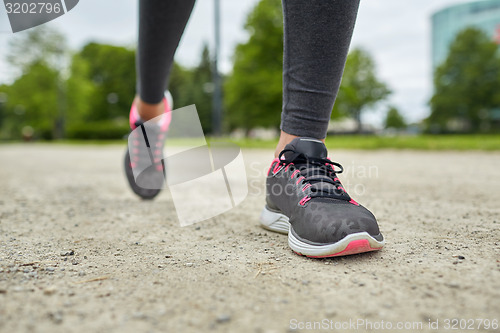 Image of close up of woman feet running on track from back