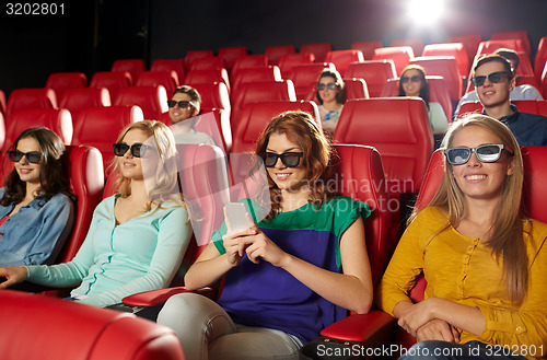 Image of happy woman with smartphone in 3d movie theater