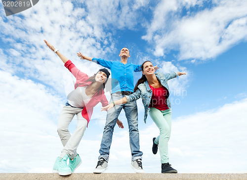 Image of group of teenagers spreading hands