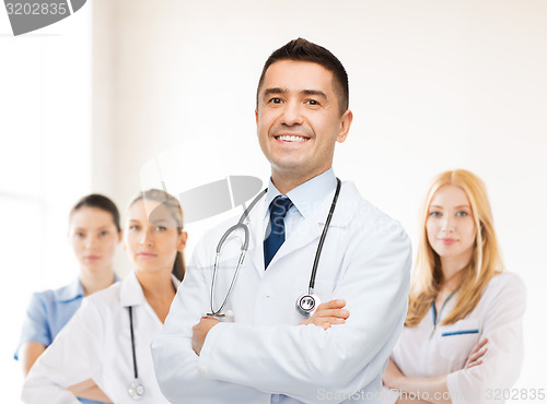 Image of smiling male doctor in white coat at hospital