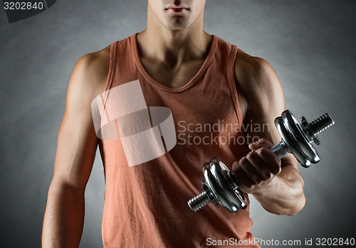 Image of young man with dumbbell