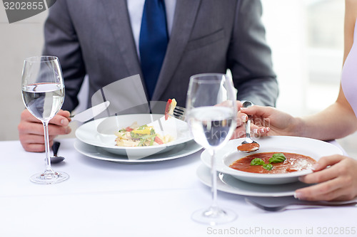 Image of close up of couple eating appetizers at restaurant