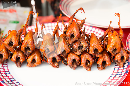 Image of grilled or fried quail on plate at street market